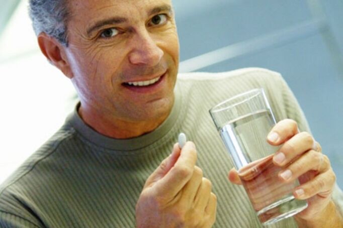 A man takes pills to treat prostatitis